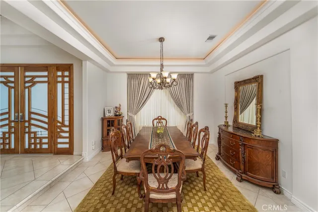 a living room with furniture a flat screen tv and kitchen view