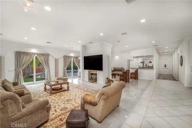 a kitchen with stainless steel appliances kitchen island granite countertop a refrigerator and a sink