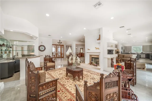 a kitchen with granite countertop a table chairs stove and cabinets