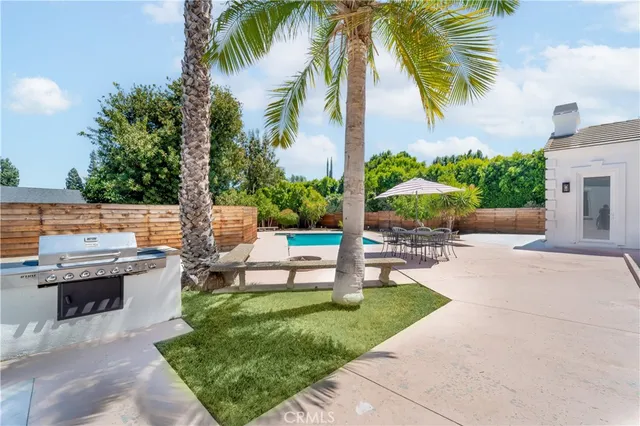 a view of a backyard with swimming pool