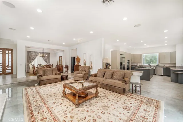 a living room with fireplace furniture and a chandelier