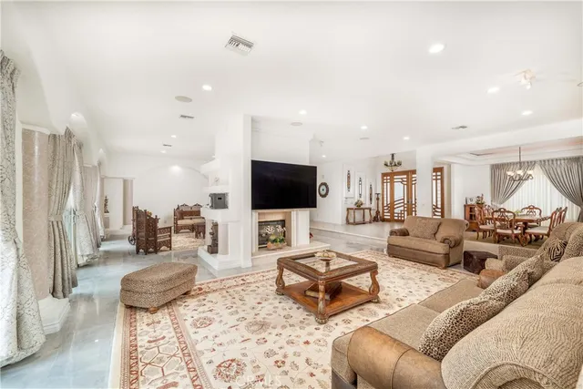a living room with furniture and kitchen view