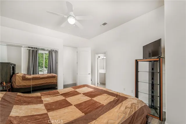 a bathroom with a granite countertop sink a toilet and shower