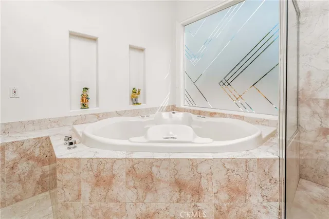 a view of a backyard with swimming pool and sitting area