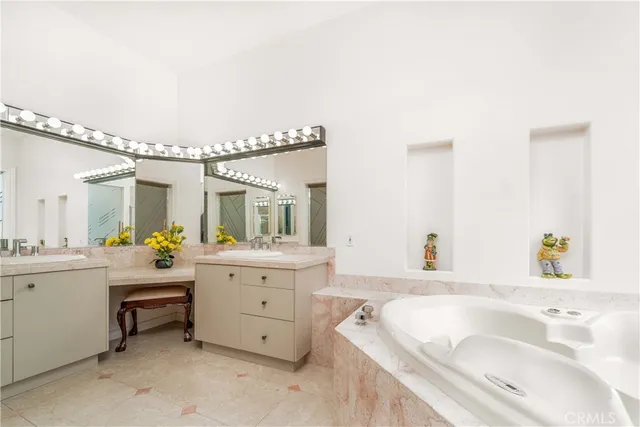 a white house with a yard and potted plants