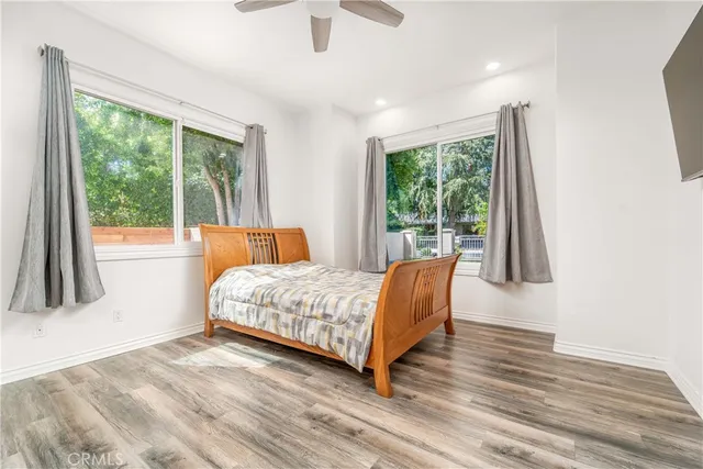 a view of a patio with a table and chairs under an umbrella with potted plants