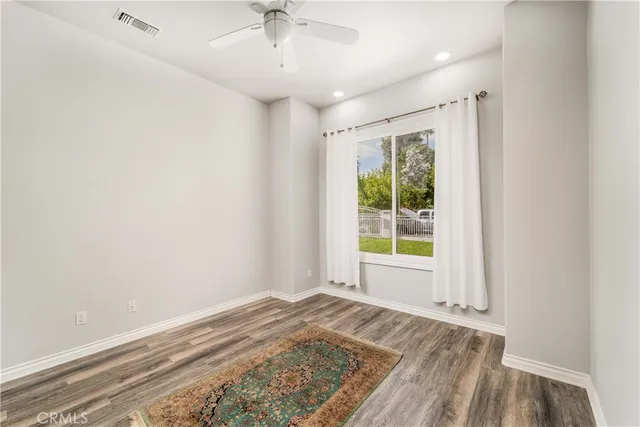 a front view of a house with a yard and potted plants
