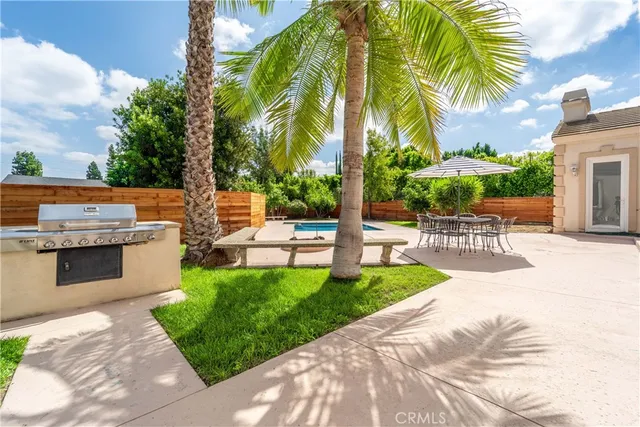 a front view of a house with a yard and potted plants