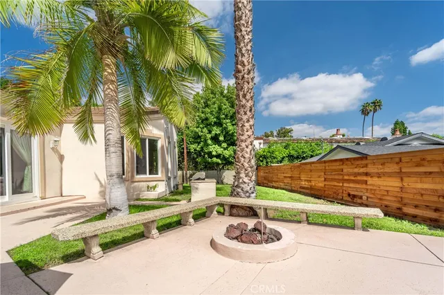 a bathroom with a granite countertop sink toilet and mirror