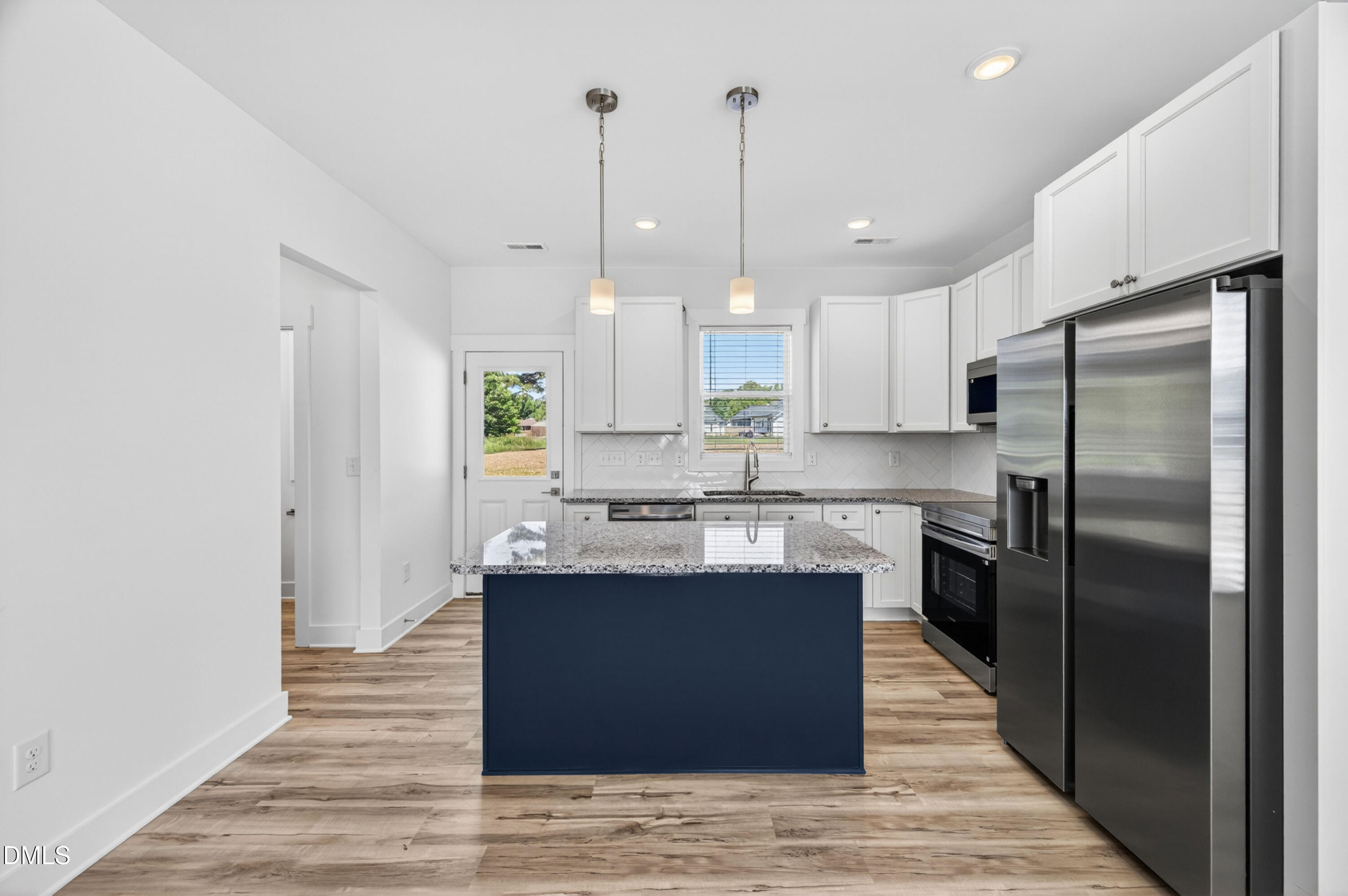 1256 Hurdle Mills Road Roxboro, NC 27573 - Photo 15 of 48 a large kitchen with stainless steel appliances granite countertop a sink a stove and a refrigerator