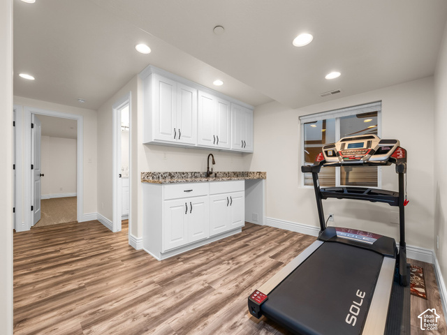 1288 North Horizon View Loop Elk Ridge, UT 84651 - Photo 21 of 38 Wood-finish flooring with white cabinetry, granite-style countertop, and a matte black faucet