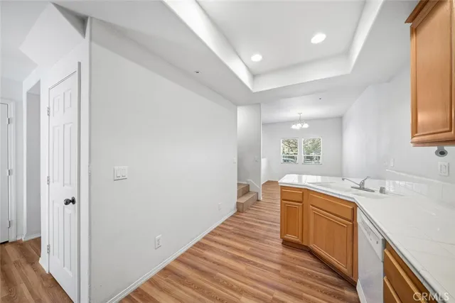 a view of a kitchen with sink and wooden floor