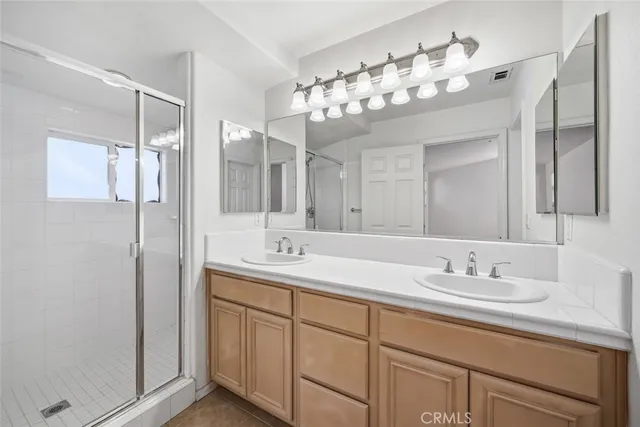 a bathroom with a double vanity sink and a mirror