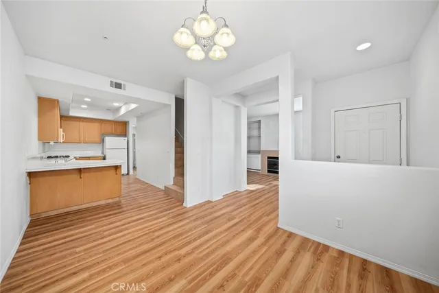 a view of a kitchen with wooden floor and a large window