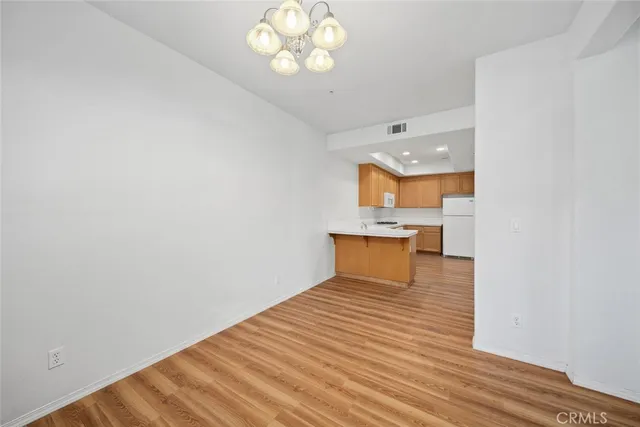 a view of a room with wooden floor and a window