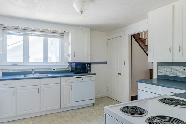 31 Bickford Road Braintree, MA 02184 - Photo 14 of 28 a kitchen with stainless steel appliances granite countertop a sink stove and cabinets