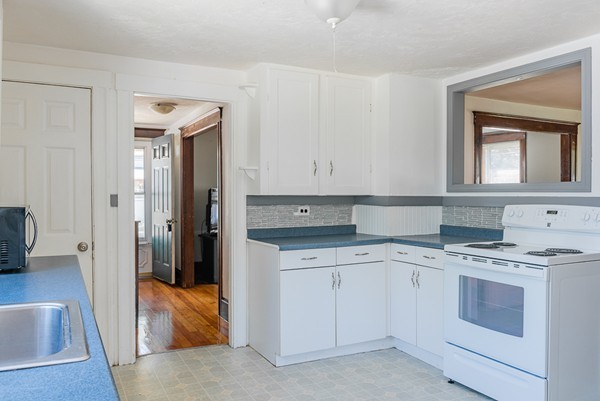 31 Bickford Road Braintree, MA 02184 - Photo 15 of 28 a kitchen with a stove sink and cabinets