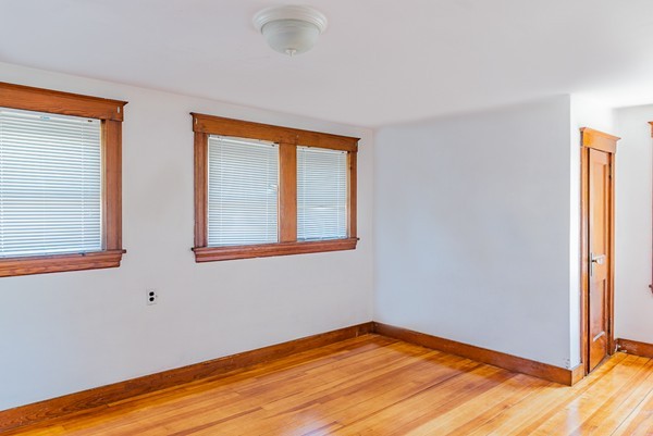 31 Bickford Road Braintree, MA 02184 - Photo 18 of 28 a view of an empty room with wooden floor and a window
