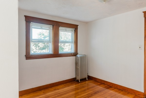 31 Bickford Road Braintree, MA 02184 - Photo 22 of 28 an empty room with wooden floor and windows