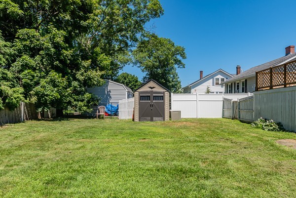 31 Bickford Road Braintree, MA 02184 - Photo 26 of 28 a house with green field in front of it