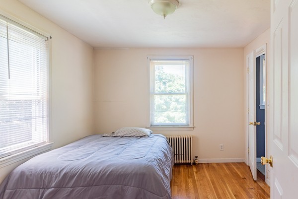 31 Bickford Road Braintree, MA 02184 - Photo 10 of 28 a bedroom with a bed and wooden floor