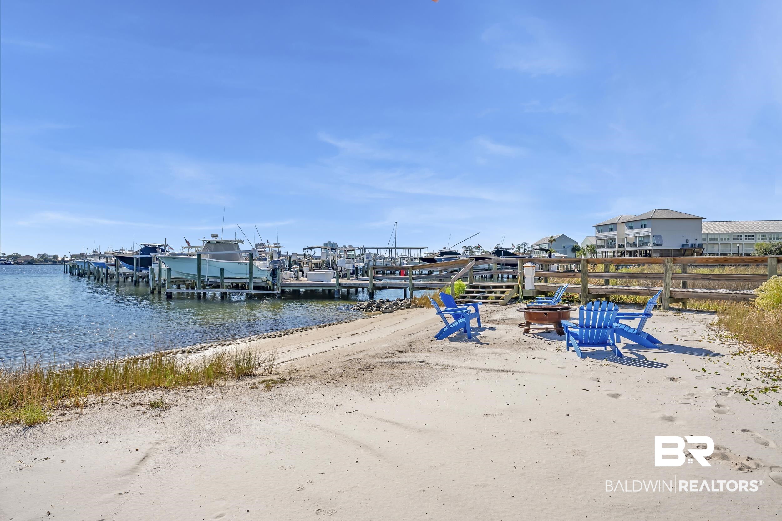 27282 Canal Road, Unit 104 Orange Beach, AL 36561 - Photo 57 of 79 Dock area featuring a water view, an outdoor fire pit, and boat lift