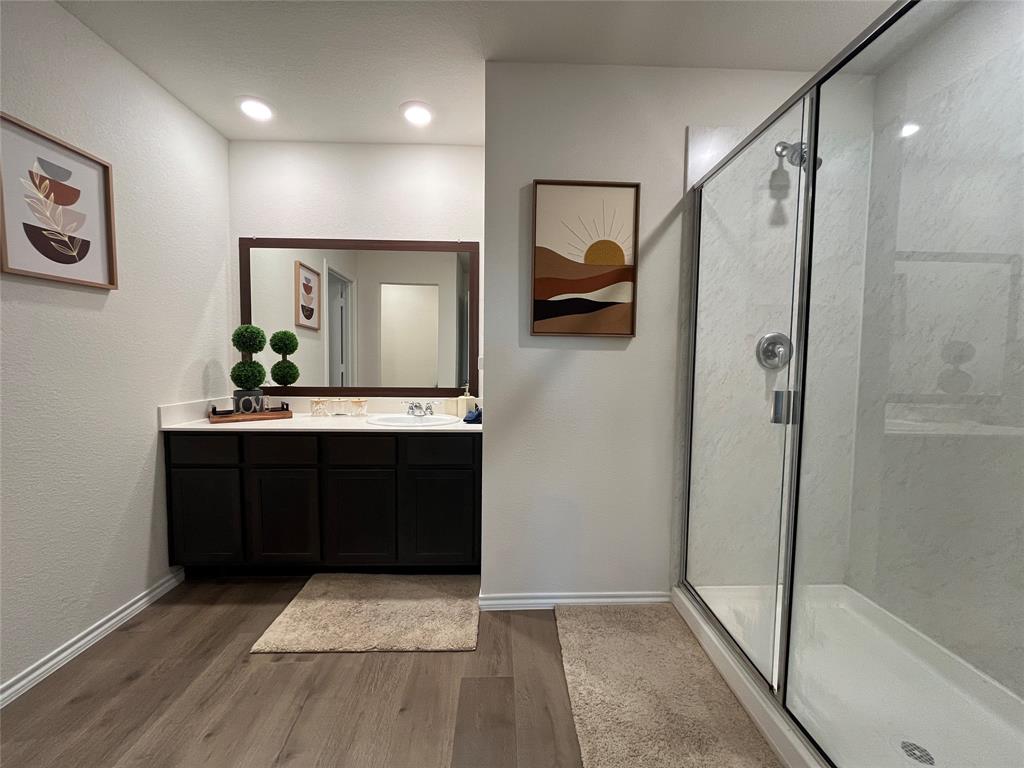 1415 Bent Spur Drive Denton, TX 76207 - Photo 10 of 26 a bathroom with a glass shower door and a sink