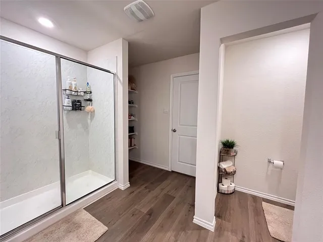a bathroom with a double vanity sink mirror and shower