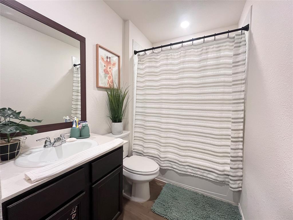 1415 Bent Spur Drive Denton, TX 76207 - Photo 15 of 26 a bathroom with a sink a toilet and shower