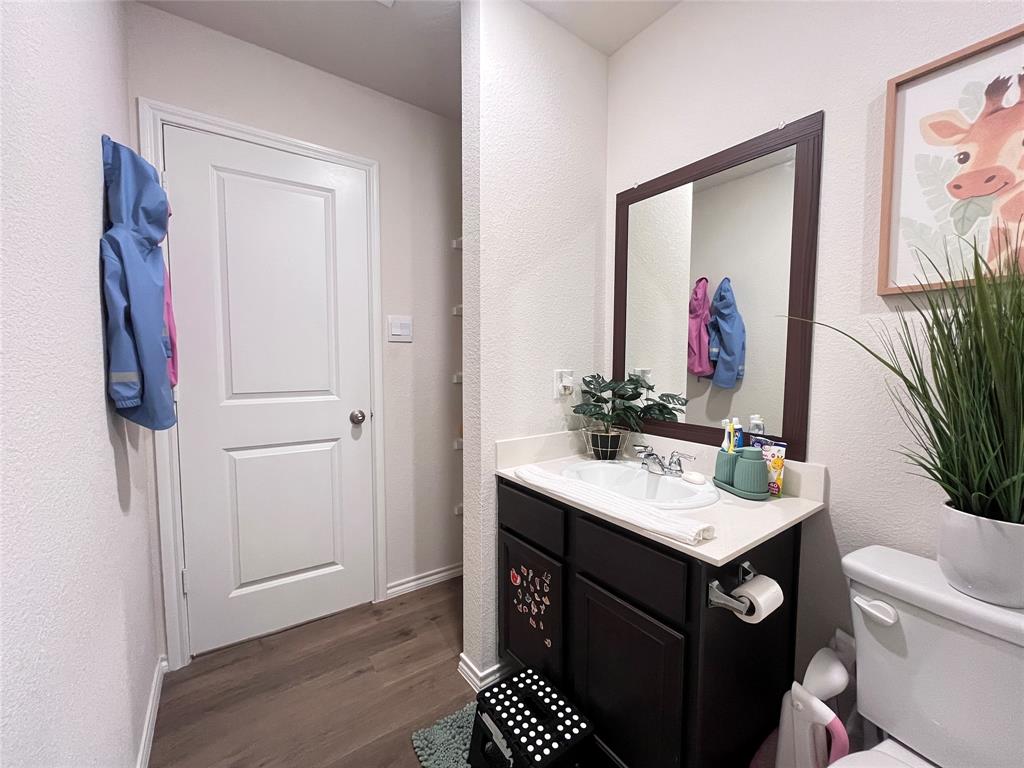1415 Bent Spur Drive Denton, TX 76207 - Photo 16 of 26 a bathroom with a sink vanity and a mirror