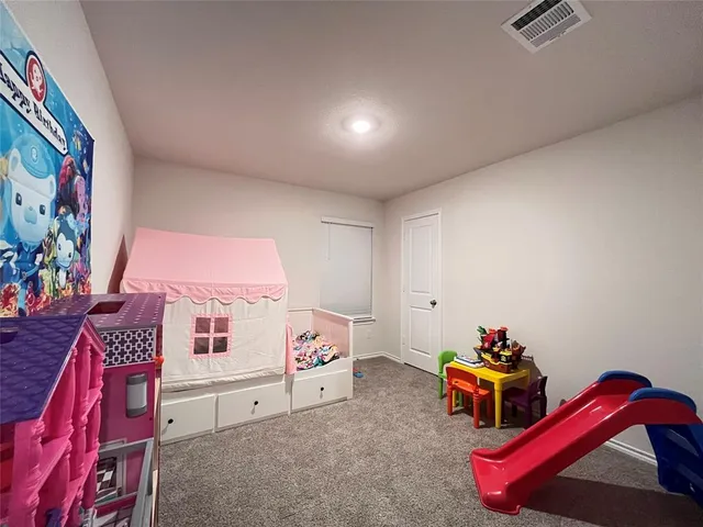 a spacious bedroom with a bed and a window