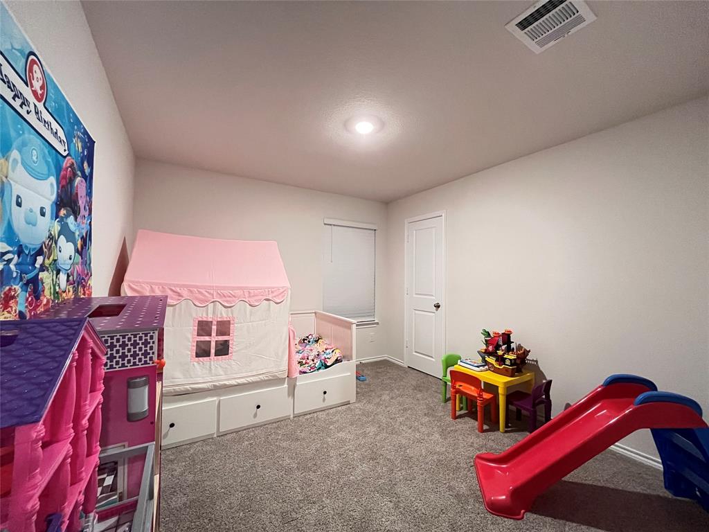 1415 Bent Spur Drive Denton, TX 76207 - Photo 18 of 26 a bedroom with furniture and a bed