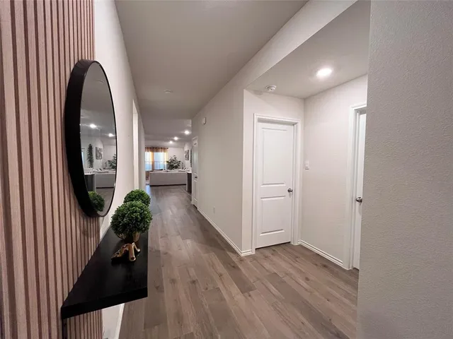 wooden floor in living room with a mirror