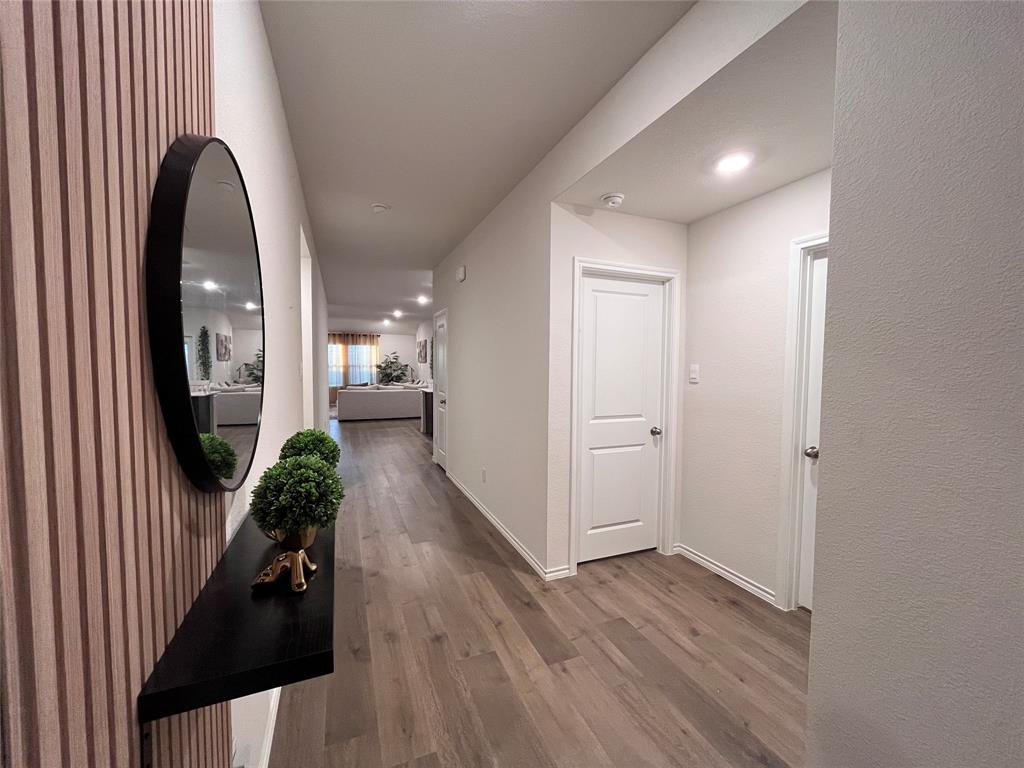 1415 Bent Spur Drive Denton, TX 76207 - Photo 2 of 26 wooden floor in living room with a mirror