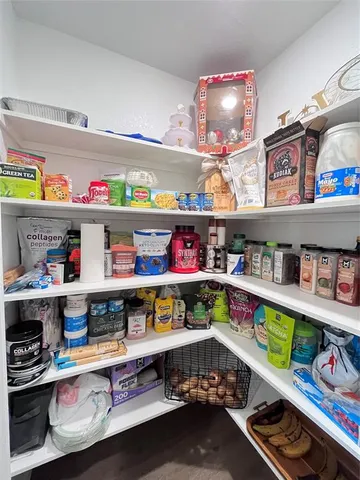 a large kitchen with kitchen island granite countertop stainless steel appliances a sink a counter top space cabinets and a center island