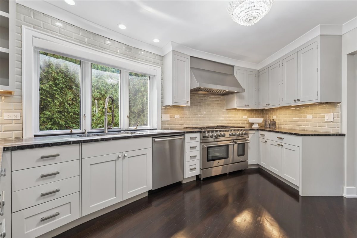 331 Sheridan Road Winnetka, IL 60093 - Photo 14 of 82 a kitchen with stainless steel appliances granite countertop a stove a sink and white cabinets
