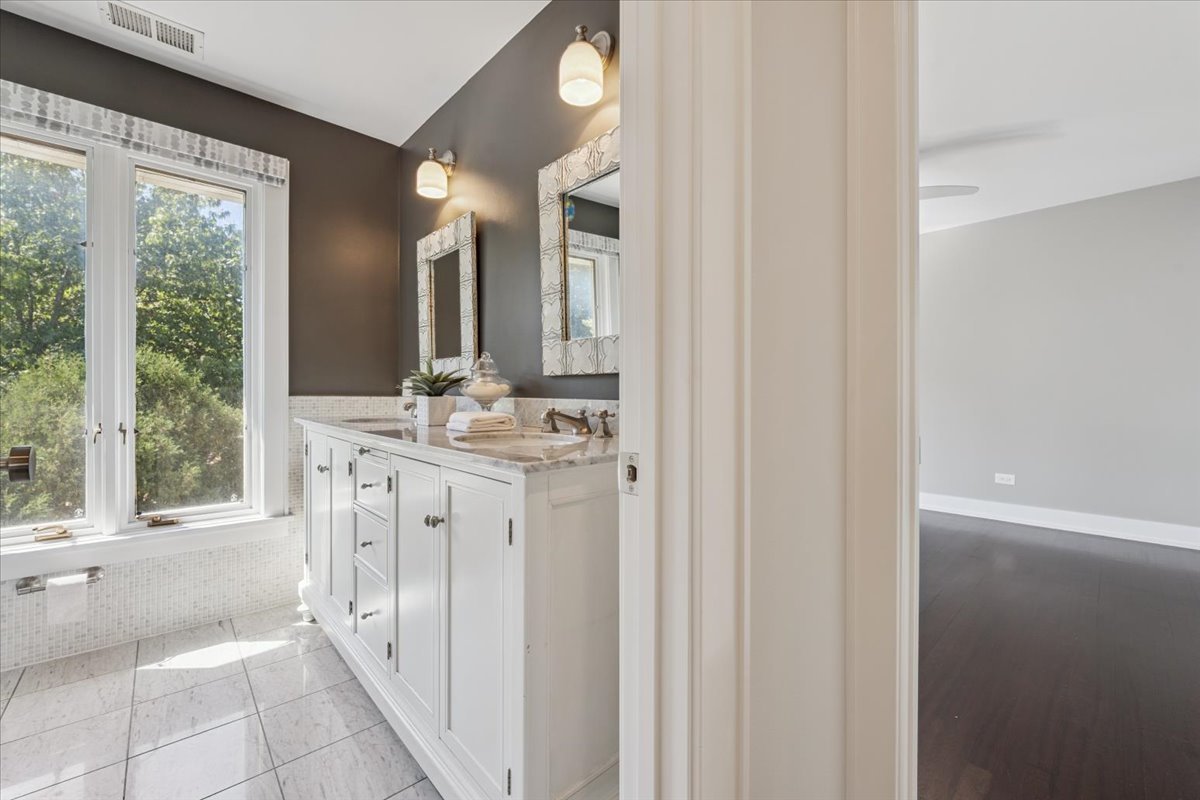 331 Sheridan Road Winnetka, IL 60093 - Photo 57 of 82 a bathroom with a double vanity sink and a mirror