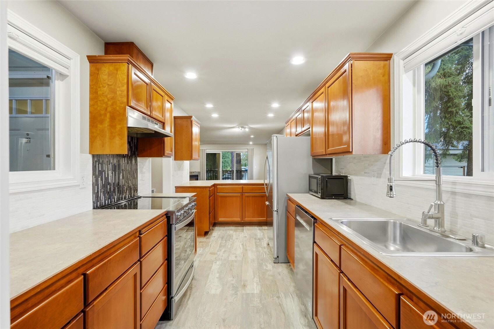 7809 218th Street Southwest, Unit 12 Edmonds, WA 98026 - Photo 12 of 34 a kitchen with stainless steel appliances granite countertop sink stove and cabinets
