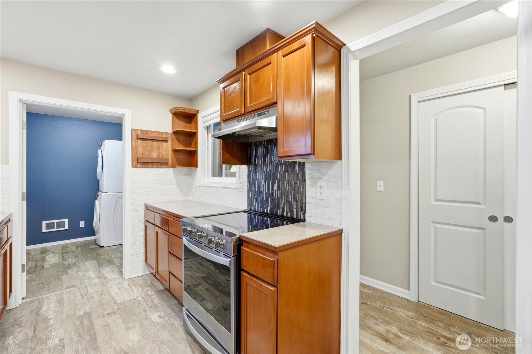 7809 218th Street Southwest, Unit 12 Edmonds, WA 98026 - Photo 15 of 34 a kitchen with stainless steel appliances granite countertop a stove and a refrigerator