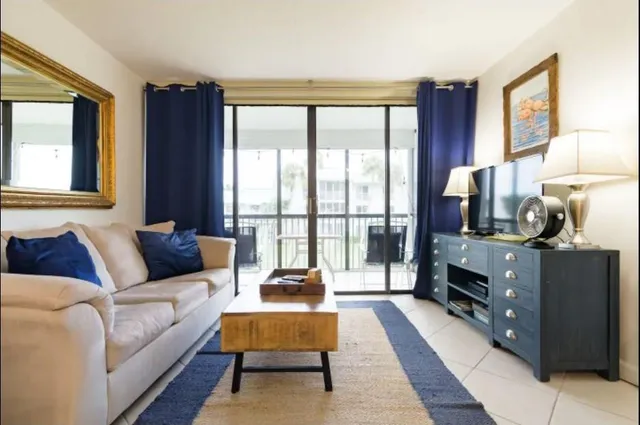 a living room with furniture and a floor to ceiling window