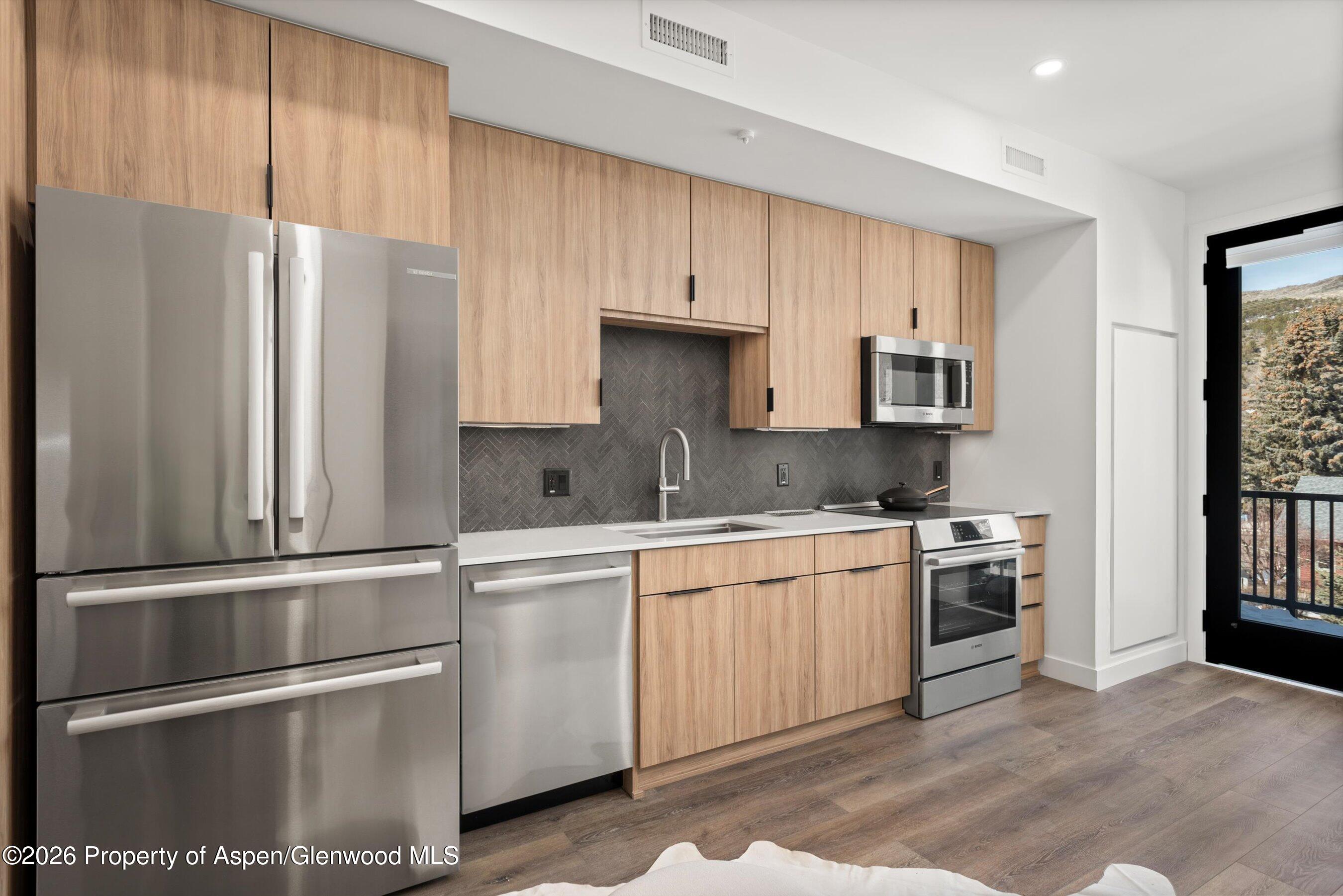 140 Basalt Center Circle, Unit 323 Basalt, CO 81621 - Photo 2 of 25 a kitchen with stainless steel appliances granite countertop a refrigerator sink and stove