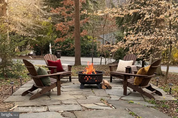 a backyard of a house with table and chairs