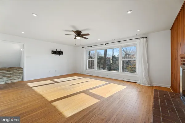 a spacious bedroom with a bed and a flat screen tv