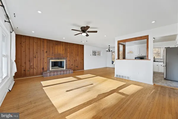 a view of a livingroom with wooden floor and stairs