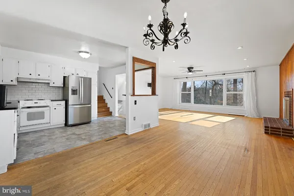 a view of a kitchen with wooden floor and a large window