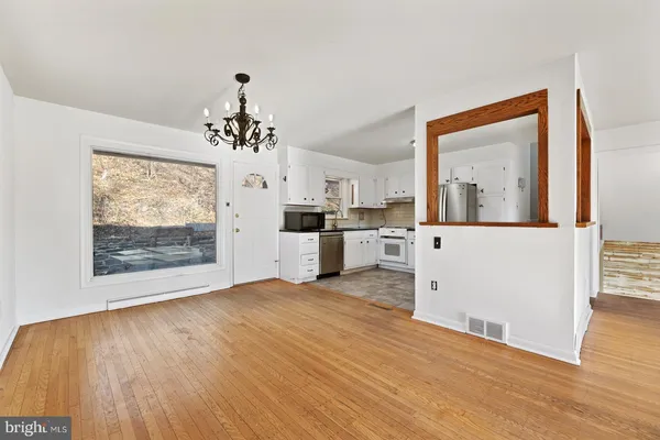 a kitchen with a stove top oven and refrigerator