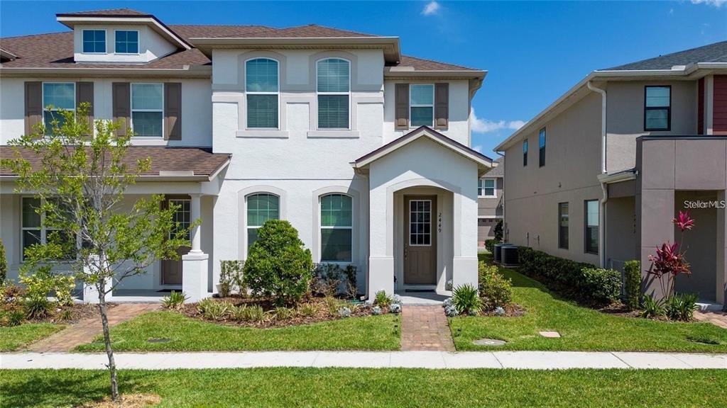 2449 Varenna Loop Kissimmee, FL 34741 - Photo 1 of 25 a front view of a house with a yard