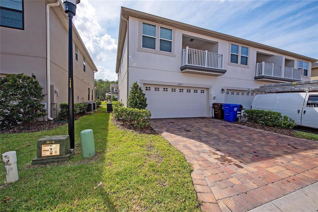 2449 Varenna Loop Kissimmee, FL 34741 - Photo 19 of 25 a front view of a house with garden