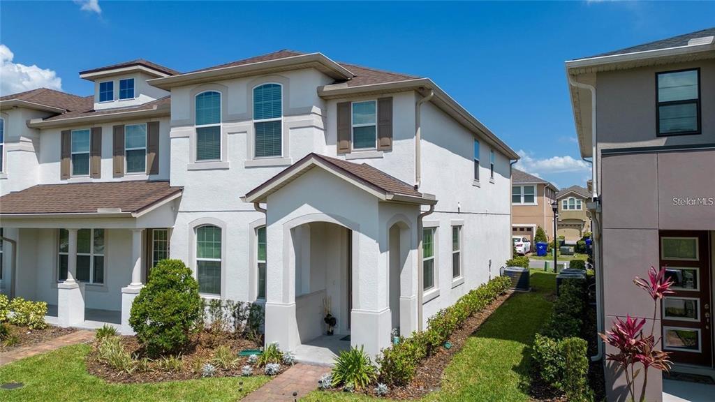 2449 Varenna Loop Kissimmee, FL 34741 - Photo 2 of 25 a front view of a house with a yard