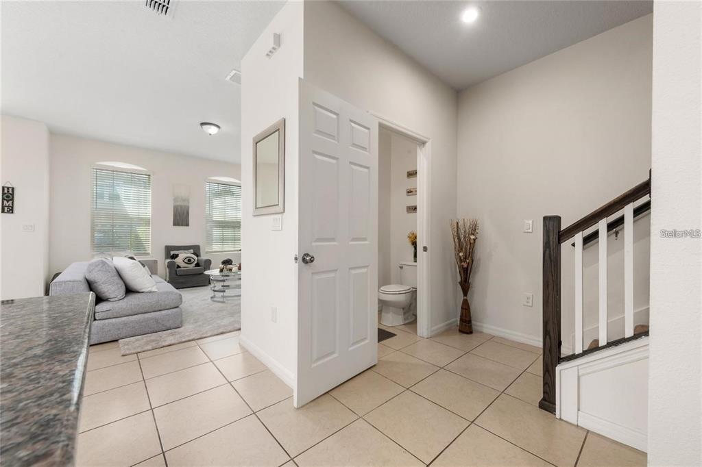 2449 Varenna Loop Kissimmee, FL 34741 - Photo 8 of 25 a living room with furniture and a refrigerator